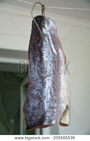 Carcass of fresh red fish hang on rope.The homemade drying of fish.