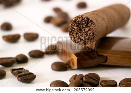 Cigar with coffee beans and lighter closeup