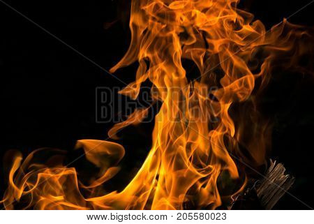 The hot flame on dark background isolated