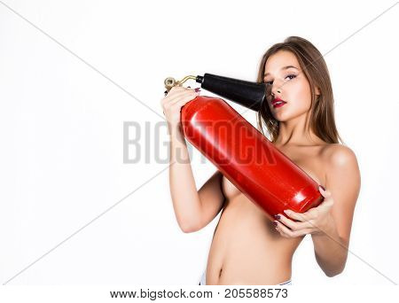 Sexy sensual female firefighter with a red fire extinguisher, with free space for your text.