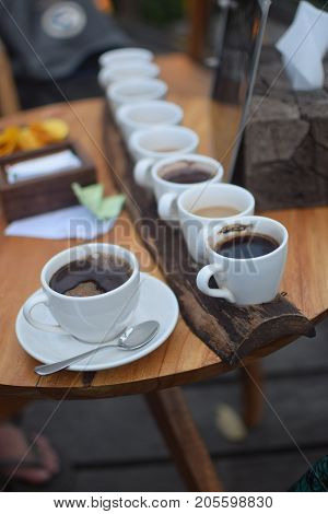 Eight kinds of coffee on a wooden tray, including Kopi Luwak, the traditional balinese coffee