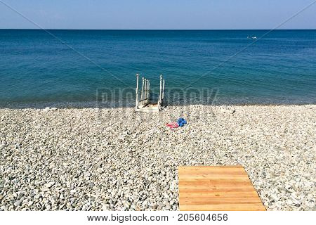 Wooden bridge ladder for descent into the sea