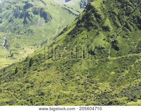 Alpine massif, beautiful Alpine canyon in Austria. Alpine Gastein Valley in summer. Mountains and pastures. Fresh air and healthy virgin nature. Excursional destination for hiking, vacation.