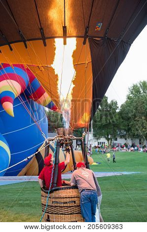 Seymour WI - August 12 2017: Hot air balloon crew preparing for launch during Hamburger Fest in Seymour WI. Hot air balloons are an integral part of the annual festival which celebrates Seymour as the birthplace of the hamburger.