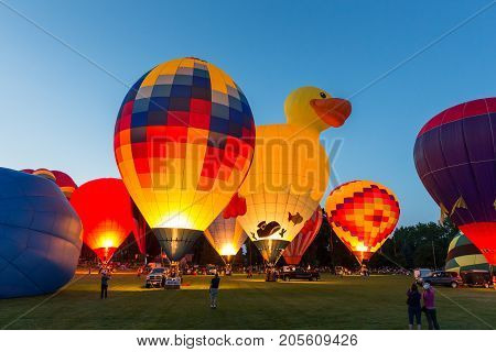 Seymour WI - August 12 2017: Hot air balloon glow during Hamburger Fest in Seymour WI. Hot air balloons are an integral part of the annual festival which celebrates Seymour as the birthplace of the hamburger.