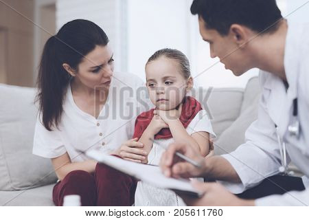 The little girl caught a cold. Her mother called the doctor at home. Doctor interrogates the girl. The girl has a sore throat and she holds her hands