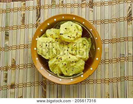 Kashmiri dum aloo - baby potatoes in a spicy vibrant curd based gravy.