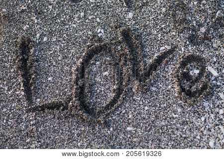 a message of love written in the sand.