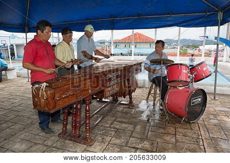 January 11, 2015 Flores, Guatemala: Men Playing Marimba Music On The Street Of The Popular Tourist D