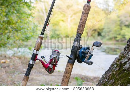 Two fishing rods with reels. One reel spinning and second baitcasting reel
