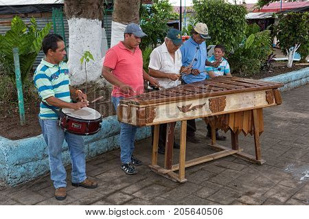 January 11, 2015 Flores, Guatemala: Men Playing Marimba Music On The Street Of The Popular Tourist D