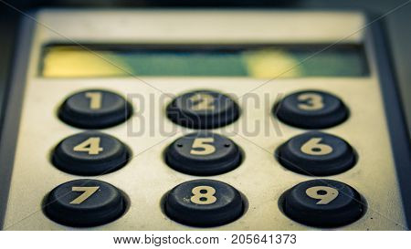 Internet security pin code device with number buttons.  Fall off focus and split toning