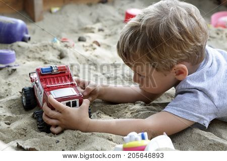 Child Playing With Toy Car