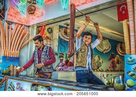 ISTANBUL TURKEY: Young dondurma ice-cream sellers dressed in traditional Turkish costume in the street shop on May 2 2017