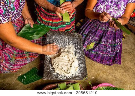January 20, 2015 San Pedro La Laguna, Guatemala: Mayan Women In Traditional Wear Preparing Food Toge
