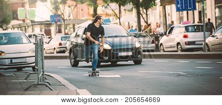 Professional Skater Riding Skate On Streets Through Cars And Traffic