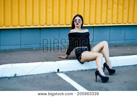 Gorgeous Brunette Girl With A Beautiful Make-up In Fashionable Clothes: A Black Blouse And Shorts Wi