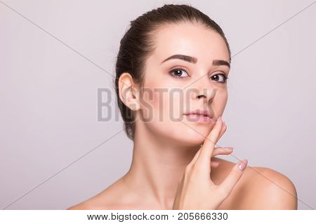 Beautiful Woman Face Close Up Hand Touching Face Studio On Gray
