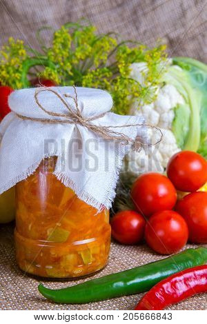 jars with winter supplies, banks with salad are on the table with vegetables