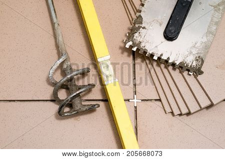 Tiling, Tile Trimming, Metering And Cutting. Repair Of The Floor. Sliced Gres Tiles.