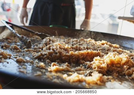 Freshly prepared juicy traditional Bavarian cabbage in a large frying pan during the octoberfest season. Soft focus and backlight.