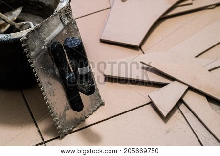 Tiling, Tile Trimming, Metering And Cutting. Repair Of The Floor. Sliced Gres Tiles.