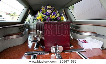 closeup shot of a colorful casket in a hearse or chapel before funeral or burial at cemetery