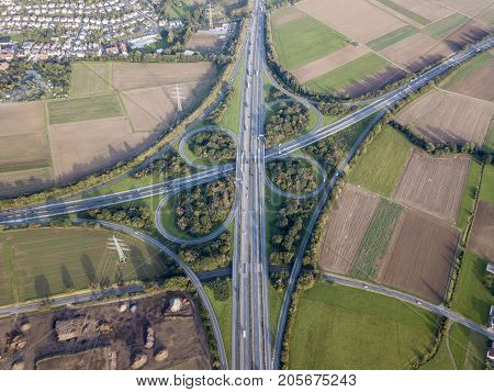 Aerial view of a highway intersection with a clover-leaf interchange
