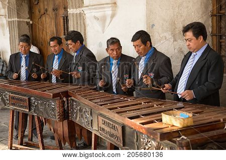 February 8 2015 Antigua Guatemala: men marimba band playing in front of a colonial building