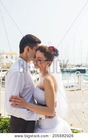 Just married couple embraced on nature. Bride and groom.