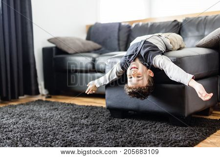 A Young Boy Relaxing On Sofa At Home