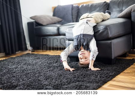 A Young Boy Relaxing On Sofa At Home