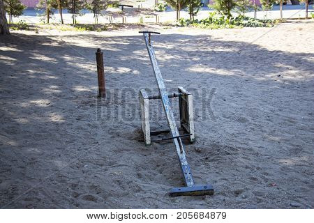 Old metal swing in an abandoned park for children