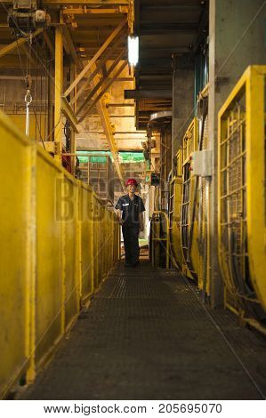 Padaeng industry Mae Sot Thailand February 20 2013: Zinc mine. Engineer walking to check machine in factory