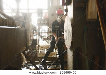 Padaeng industry Mae Sot Tak Thailand February20 2013 : Zinc mine. Engineer cleaning machine in factory.