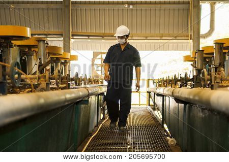 Padaeng industry Mae Sot Thailand February 20 2013: Zinc mine. Engineer walking to check machinery in factory.