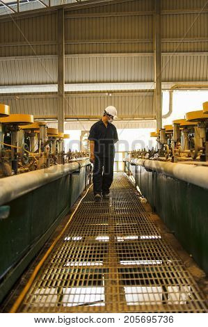 Padaeng industry Mae Sot Thailand February 20 2013: Zinc mine. Engineer walking to check machinery in factory.