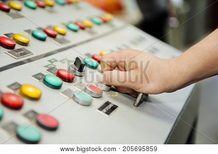 Hand of control panel board. Colorful of control panel board.