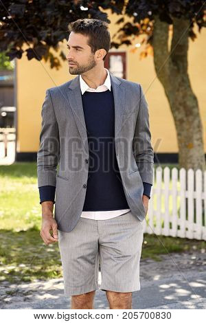 Stubble dude in grey suit jacket and shorts