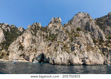 CAPRI ITALY - JUNE 13 2017: Boats with tourists near Grotta Bianca and Grotta Meravigliosa Capri Italy