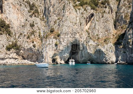 CAPRI ITALY - JUNE 13 2017: Boats with tourists near Grotta Bianca and Grotta Meravigliosa Capri Italy