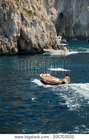 CAPRI ITALY - JUNE 13 2017: Boats with tourists near Grotta Bianca and Grotta Meravigliosa Capri Italy