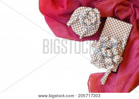Gifts and red luxury fabric isolated on white background.