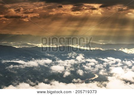 Fantastic Landscape of Sun ray from the sun over the mountain which have cloud and fog at top view of Doi Samer Dao in nan province Thailandworm white balance abstract nature concept