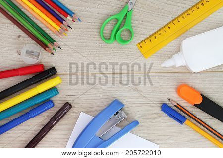 A set of stationery on a wooden background. Back to school.