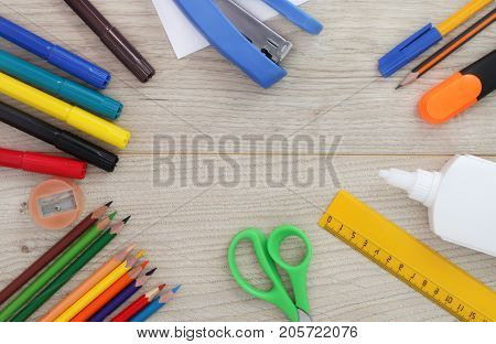 A set of stationery on a wooden background. Back to school.