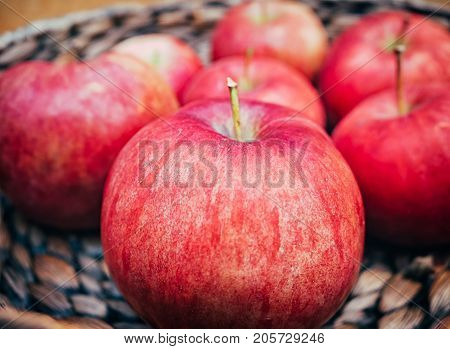 wooden basket with big red apples. Macro shot.