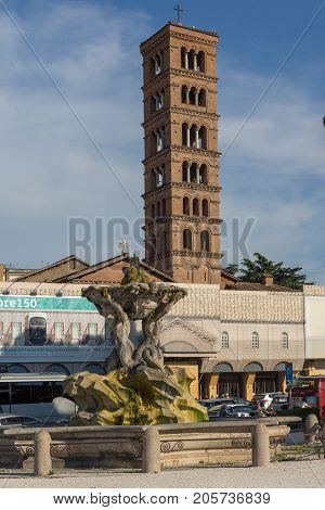 ROME, ITALY - JUNE 22, 2017:  Amazing view of Church of Santa Maria in Cosmedin and Fountain of the Tritons in city of Rome, Italy