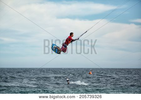 January 25 2014 Los Barriles Mexico: kiteboarder lifts off from water and leaps in air at the 'Lord of the Wind' kite surf competition