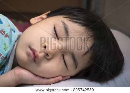 A Toddler Boy Snoozing in the Afternoon